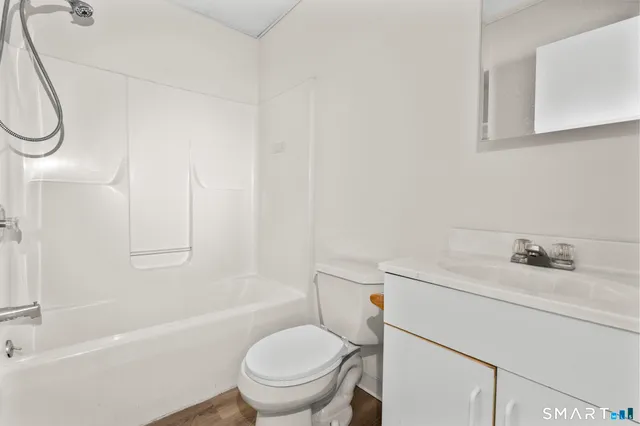 a bathroom with a toilet sink and shower