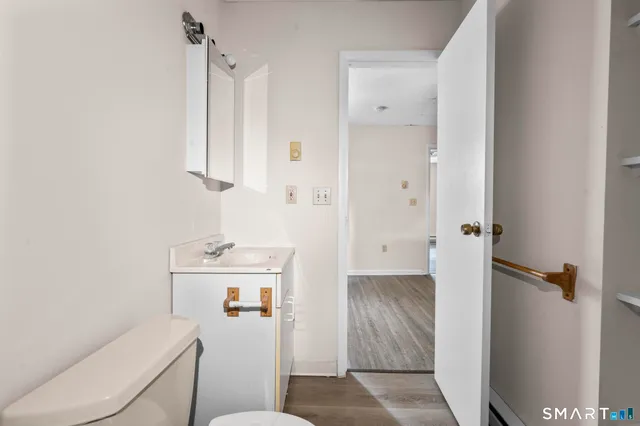 a view of an empty room with wooden floor