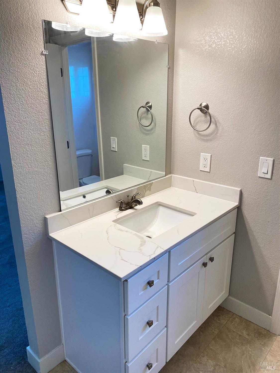 849 Finch Way Fairfield, CA 94533 - Photo 17 of 26 a bathroom with a sink and a mirror