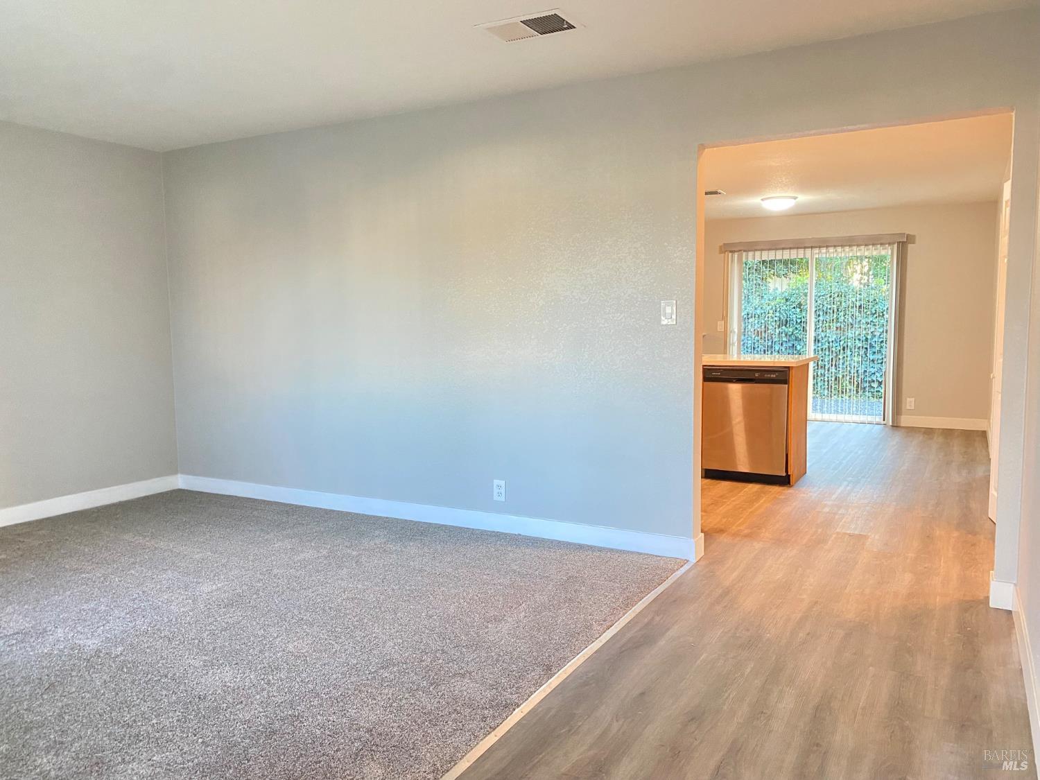 849 Finch Way Fairfield, CA 94533 - Photo 4 of 26 an empty room with wooden floor and windows