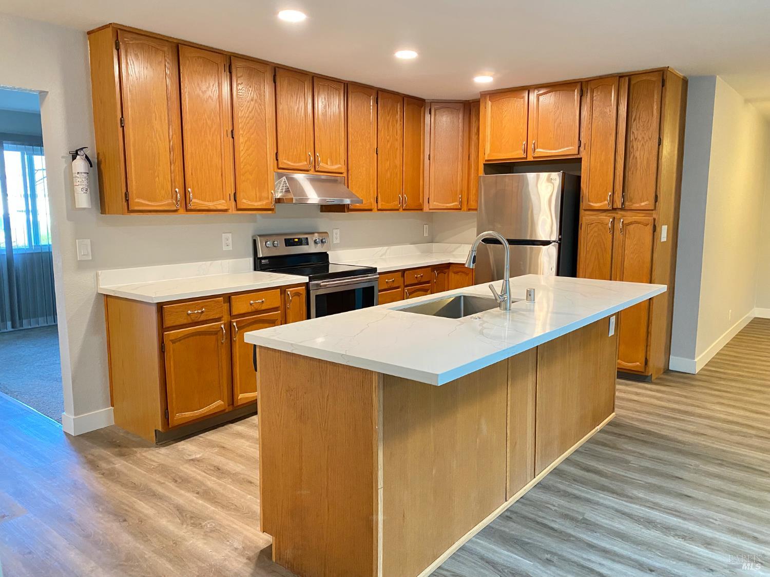 849 Finch Way Fairfield, CA 94533 - Photo 6 of 26 a kitchen with stainless steel appliances granite countertop a sink a stove a refrigerator cabinets and wooden floor