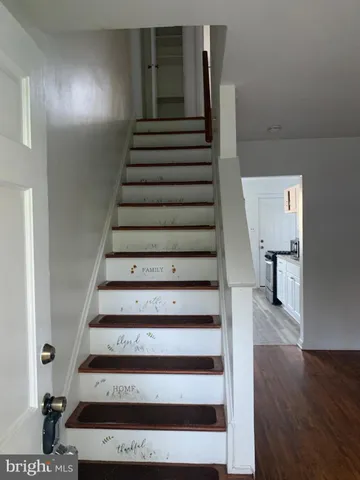 a view of entryway and hall with wooden floor
