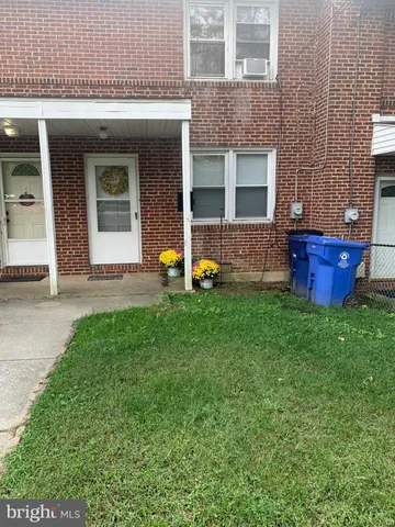 a view of an house with backyard space and a yard