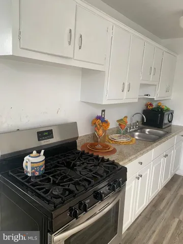 a stove top oven sitting inside of a kitchen