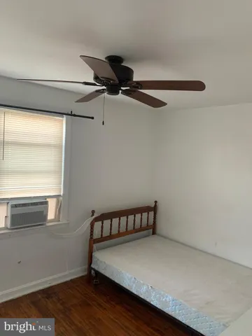 a view of a room with wooden floor and windows