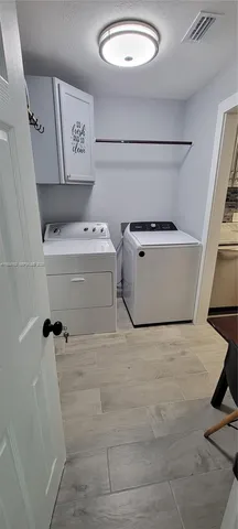 a kitchen with stainless steel appliances a stove a microwave and a refrigerator