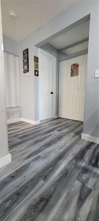 a room with wooden floor and a window