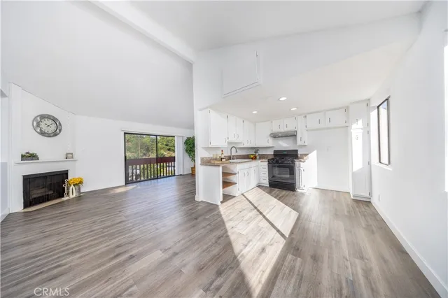 a view of kitchen with livingroom and fireplace