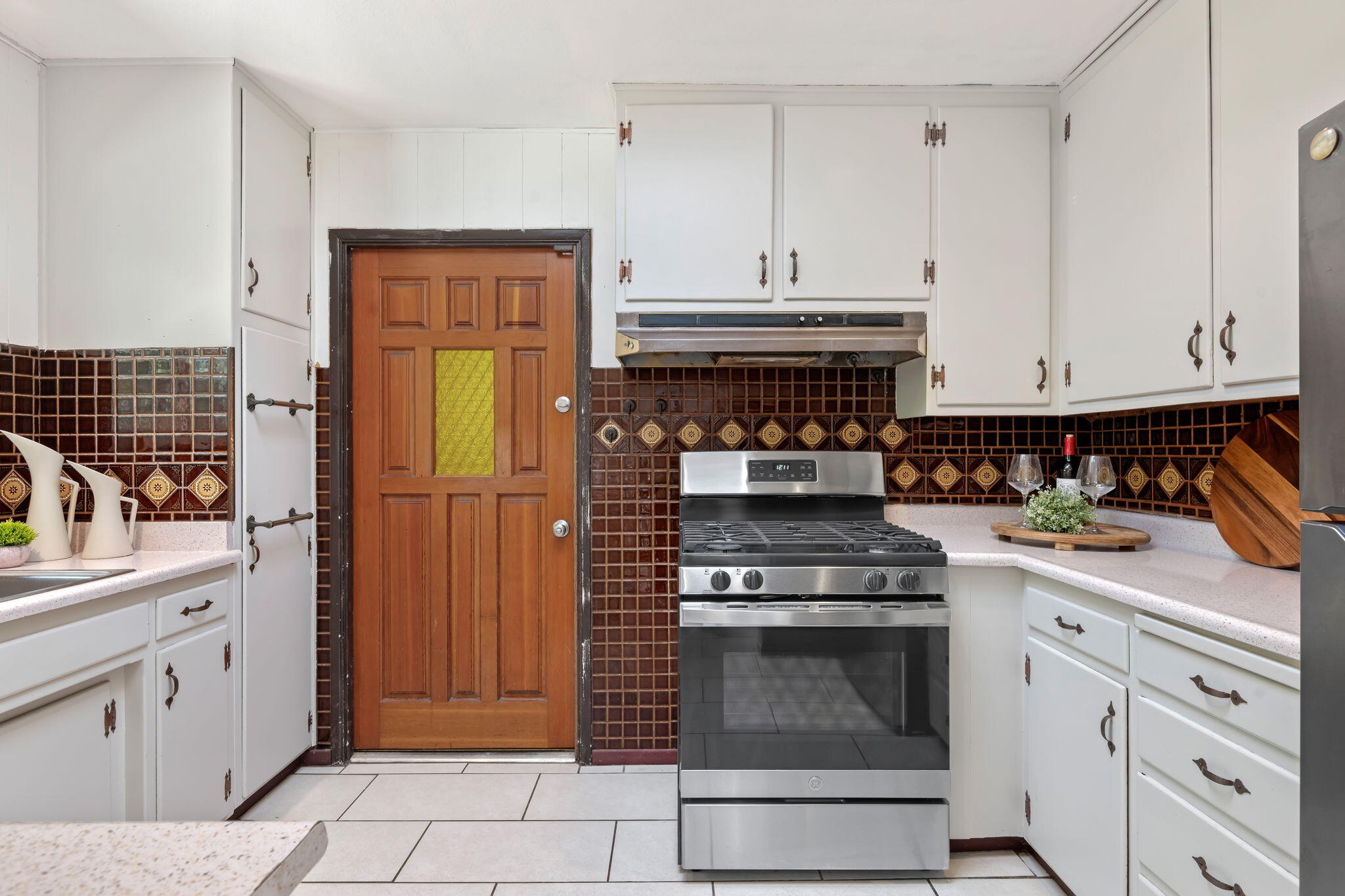 3855 Foothill Road Santa Barbara, CA 93110 - Photo 23 of 39 a kitchen with granite countertop white cabinets and stainless steel appliances