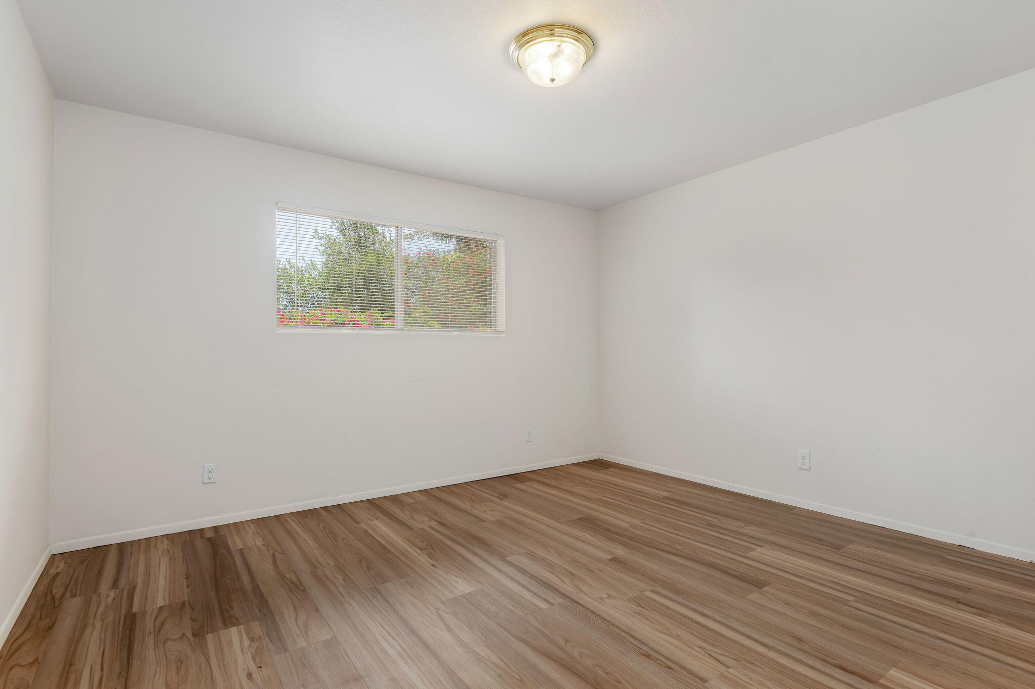 3855 Foothill Road Santa Barbara, CA 93110 - Photo 36 of 39 an empty room with wooden floor and windows