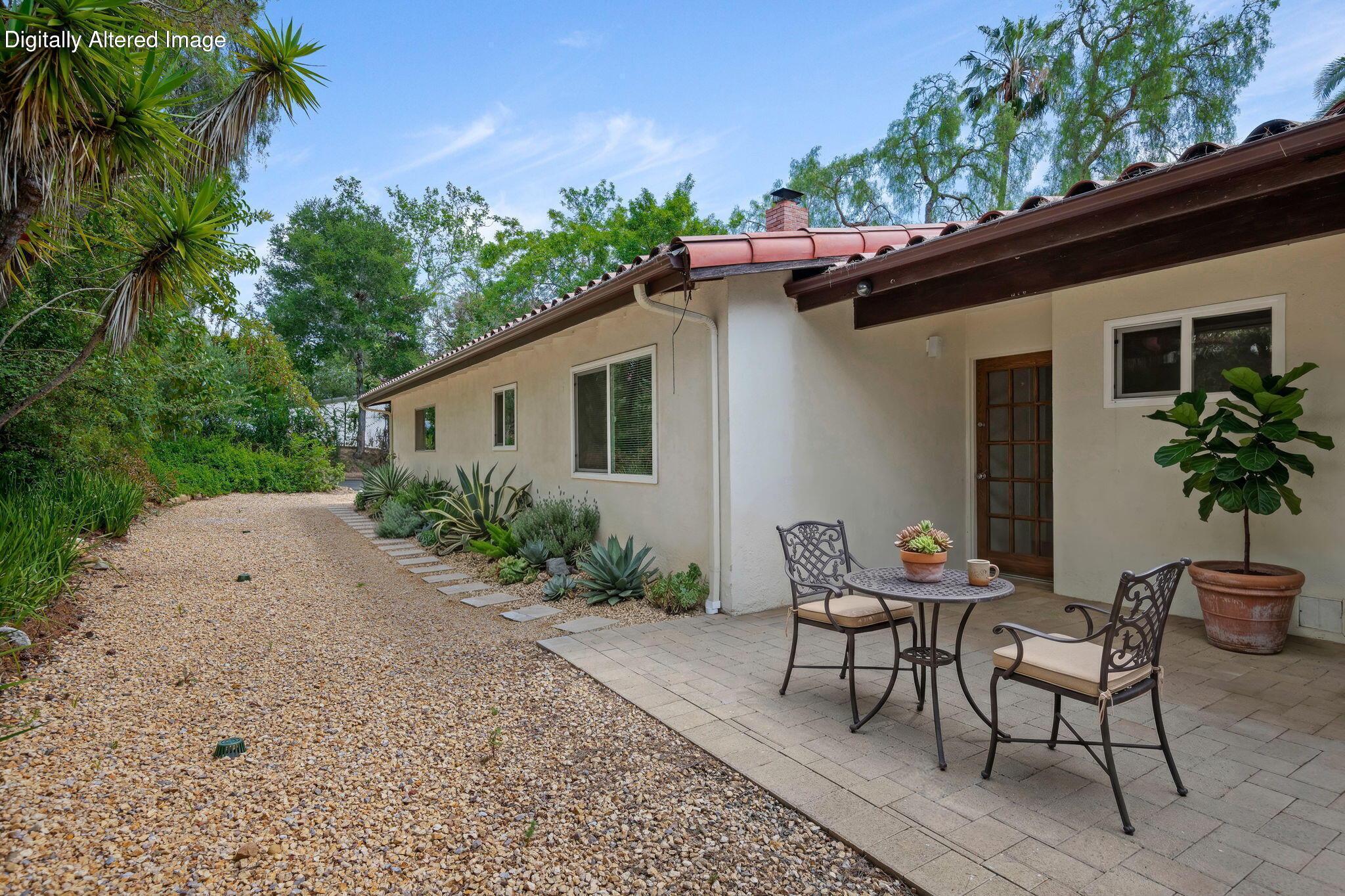 3855 Foothill Road Santa Barbara, CA 93110 - Photo 37 of 39 a backyard of a house with table and chairs and potted plants