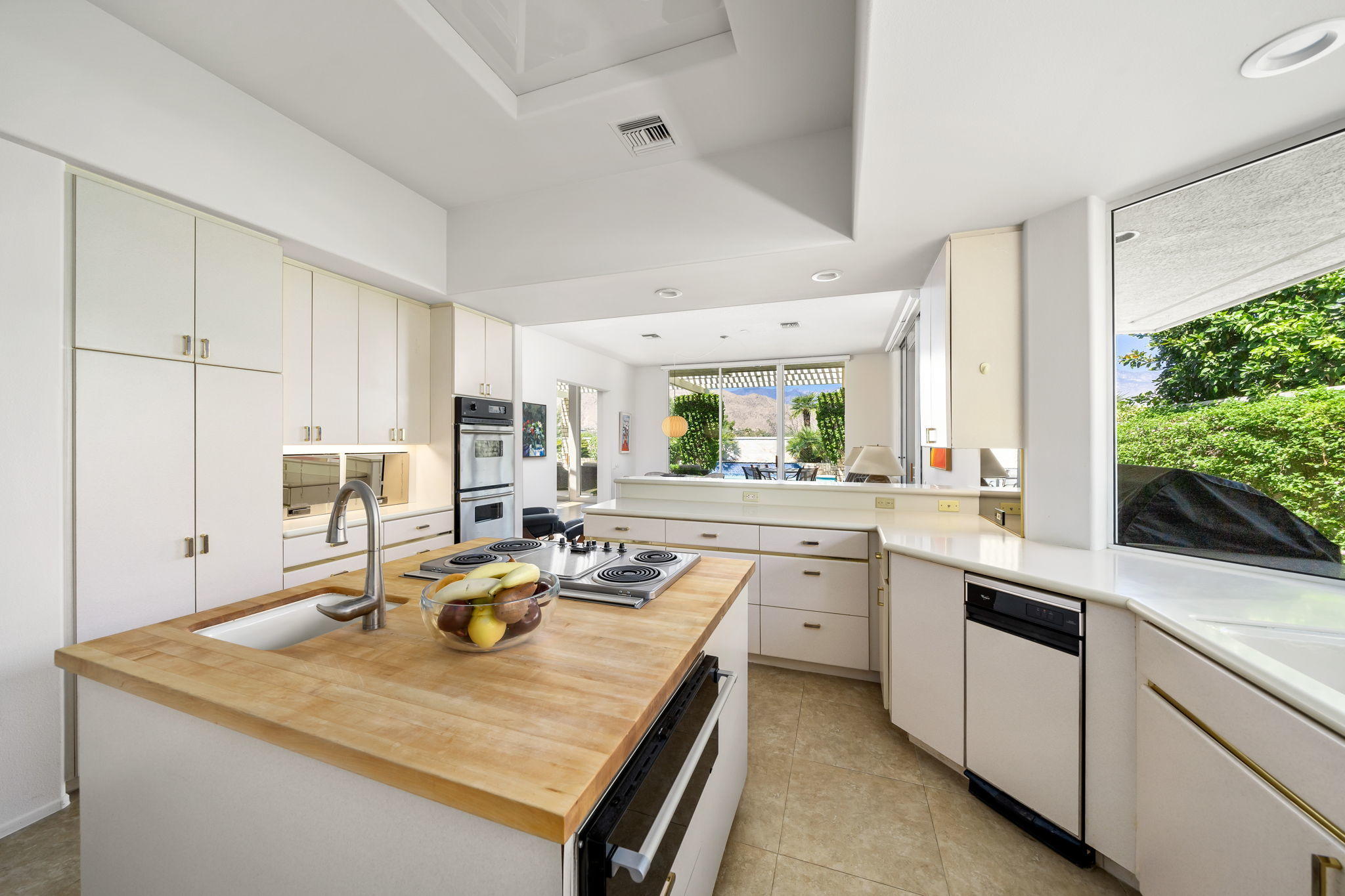 74 Mayfair Drive Rancho Mirage, CA 92270 - Photo 12 of 35 a kitchen with kitchen island a sink table and chairs
