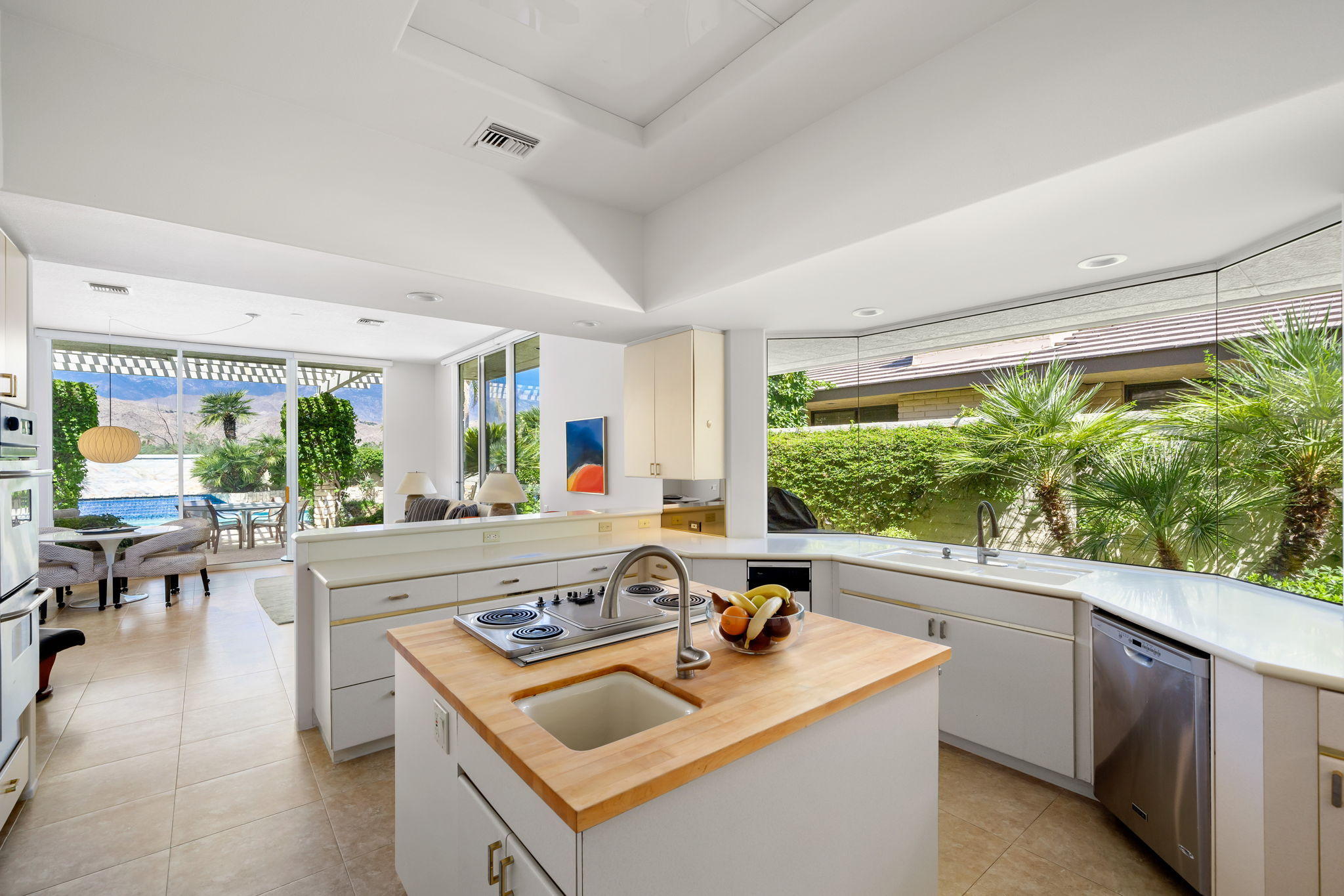 74 Mayfair Drive Rancho Mirage, CA 92270 - Photo 13 of 35 a kitchen with a stove a sink and a refrigerator