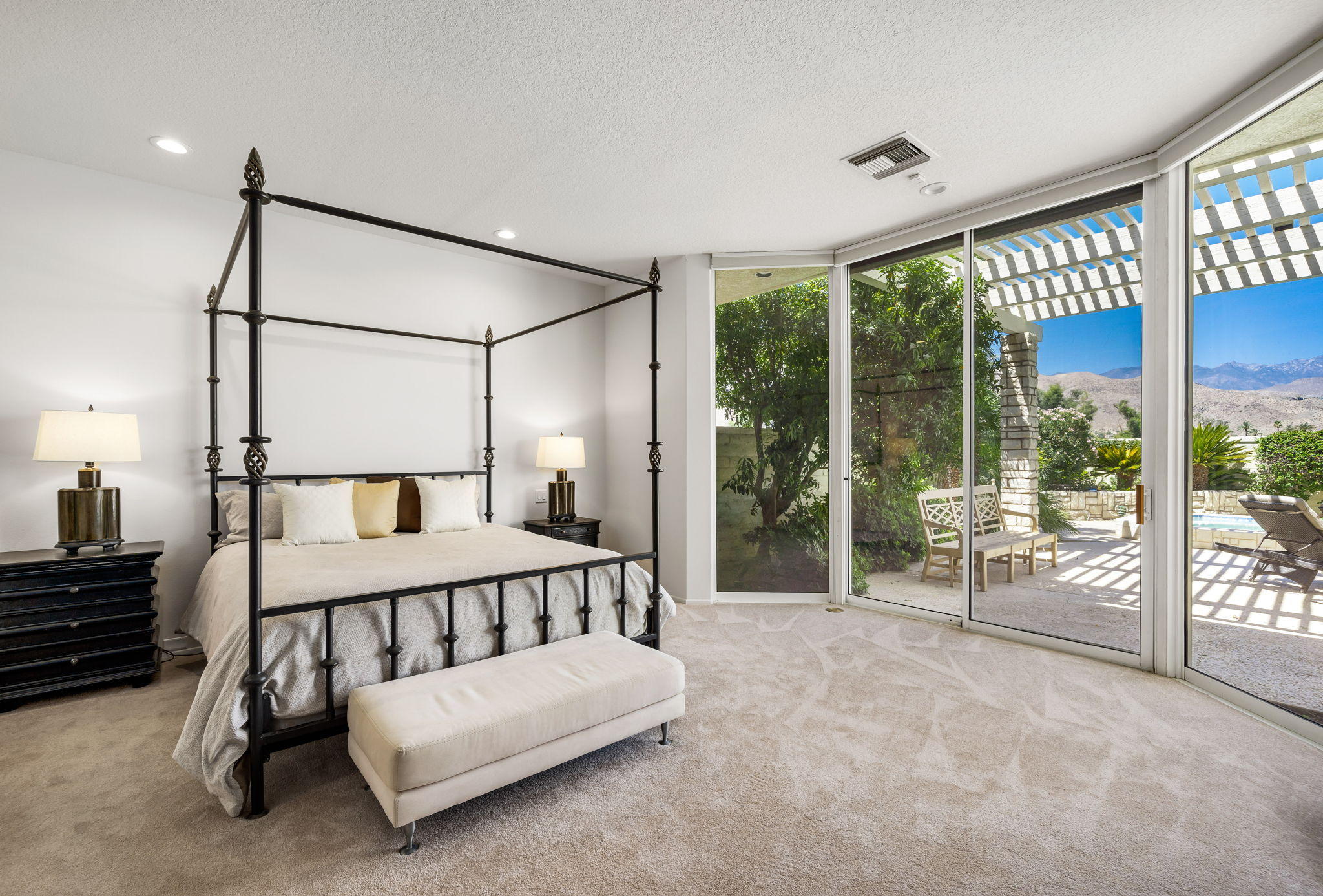 74 Mayfair Drive Rancho Mirage, CA 92270 - Photo 15 of 35 a spacious bedroom with a bed and large window