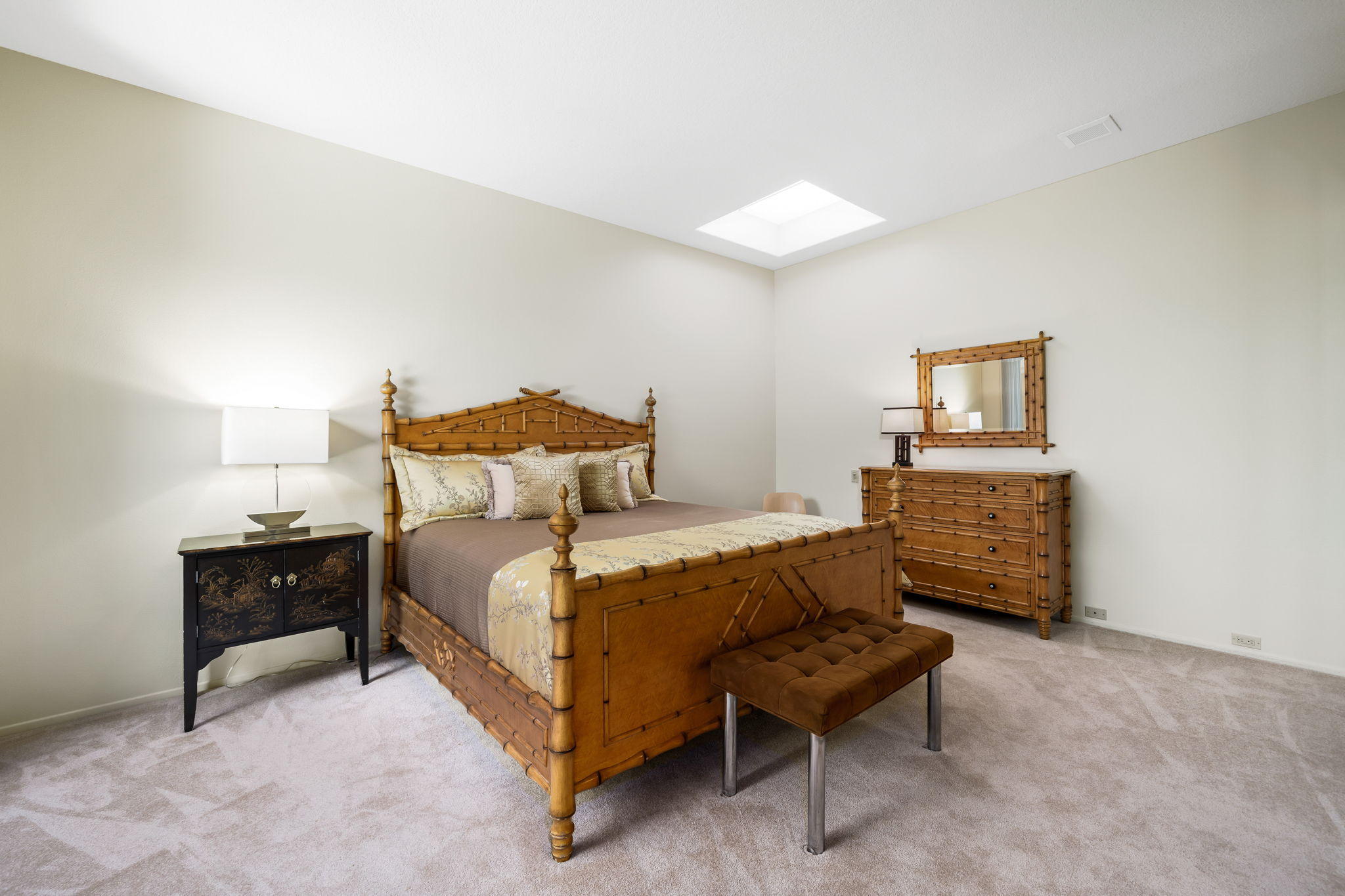 74 Mayfair Drive Rancho Mirage, CA 92270 - Photo 19 of 35 a bedroom with a bed a table and painting