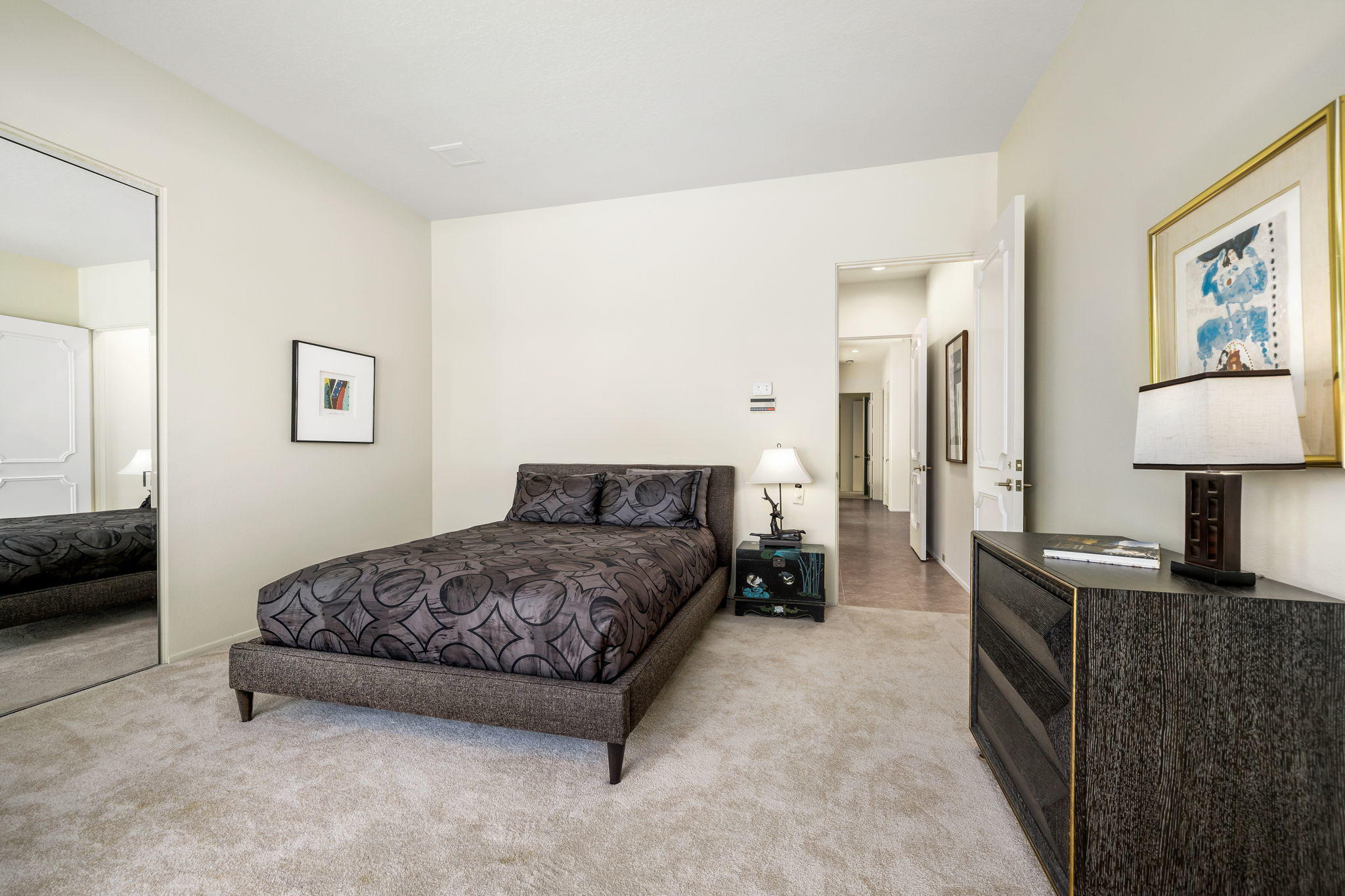 74 Mayfair Drive Rancho Mirage, CA 92270 - Photo 21 of 35 a spacious bedroom with a bed and a lamp