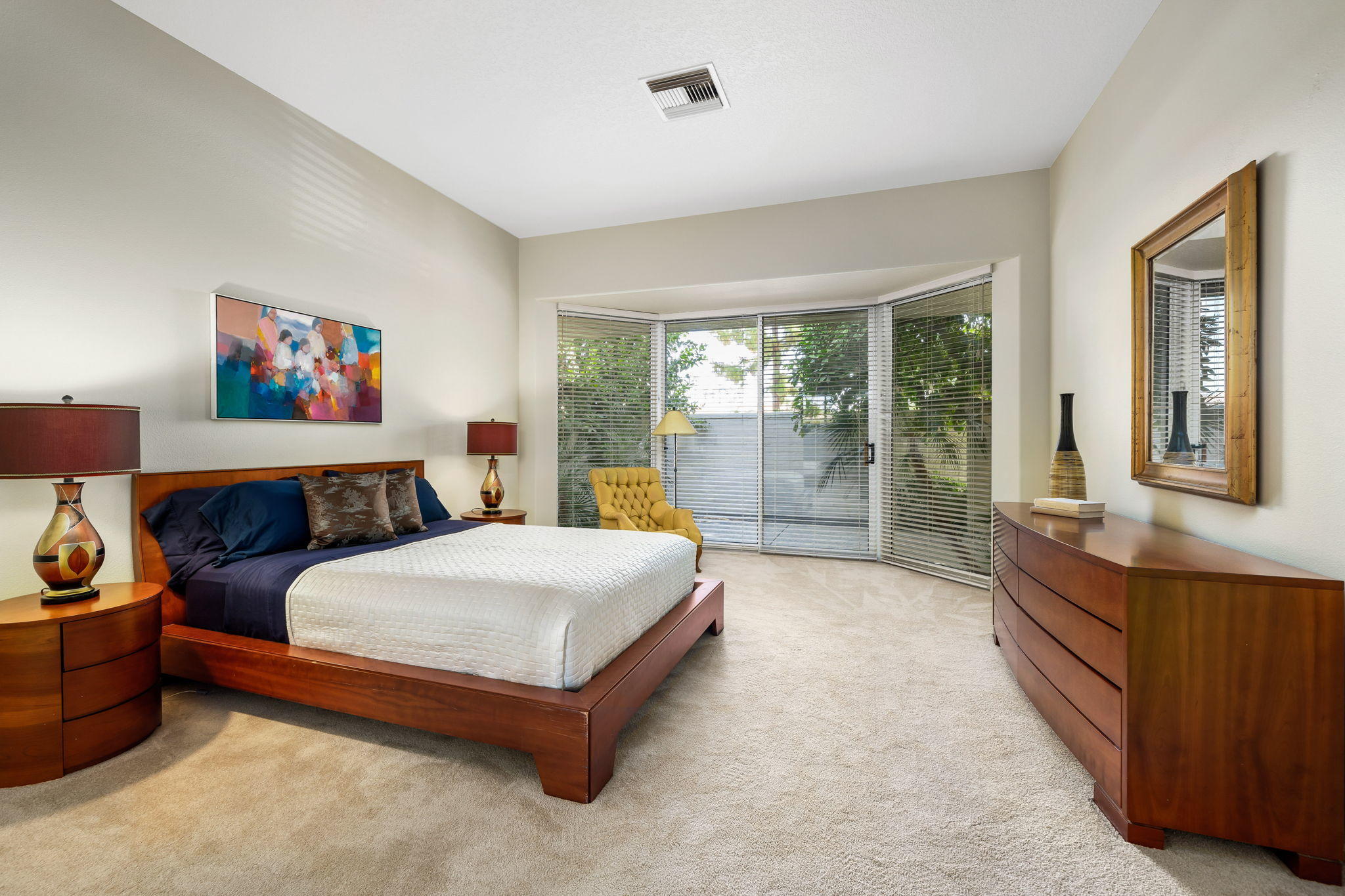 74 Mayfair Drive Rancho Mirage, CA 92270 - Photo 23 of 35 a spacious bedroom with a large bed and a large window