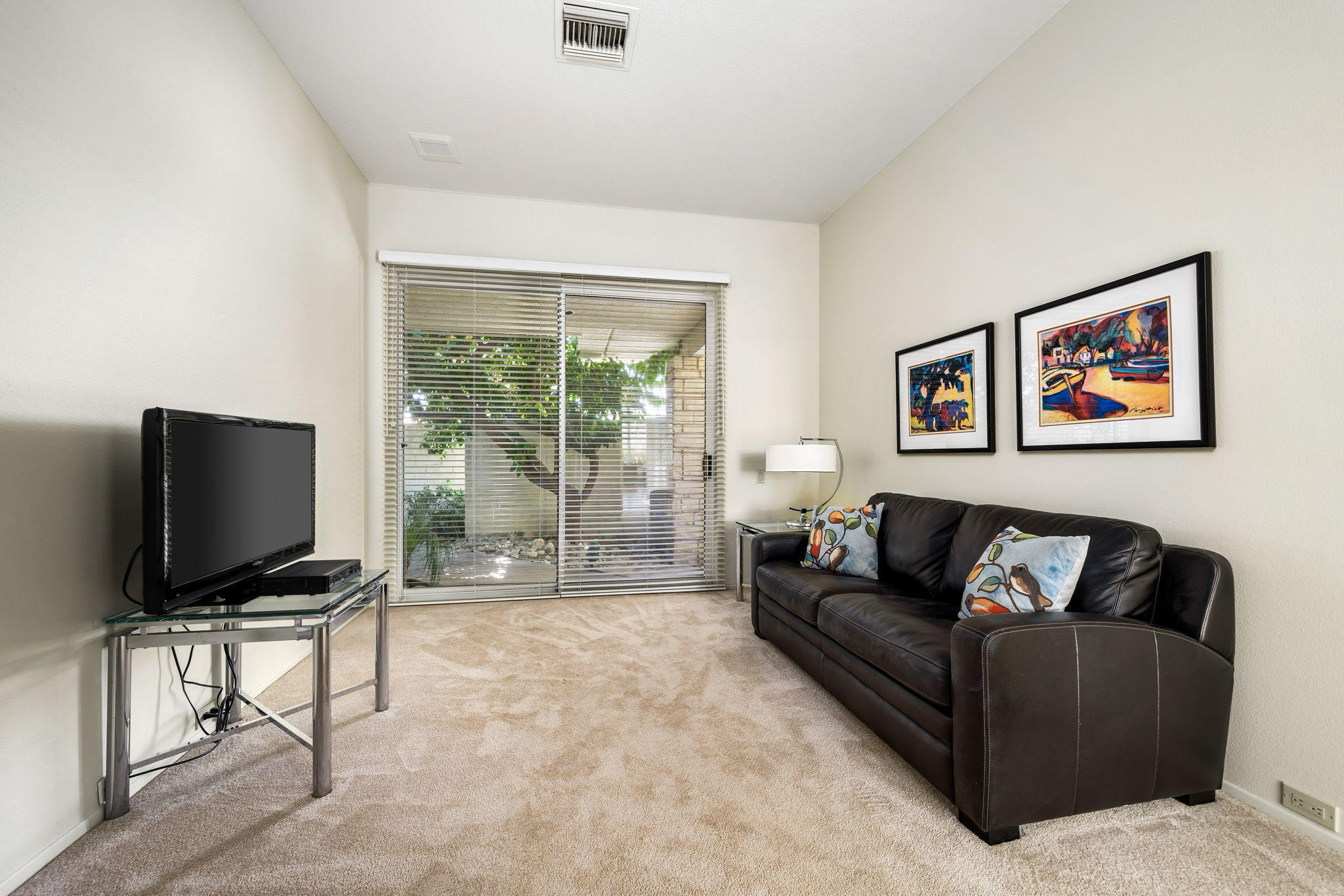 74 Mayfair Drive Rancho Mirage, CA 92270 - Photo 24 of 35 a living room with furniture and a flat screen tv