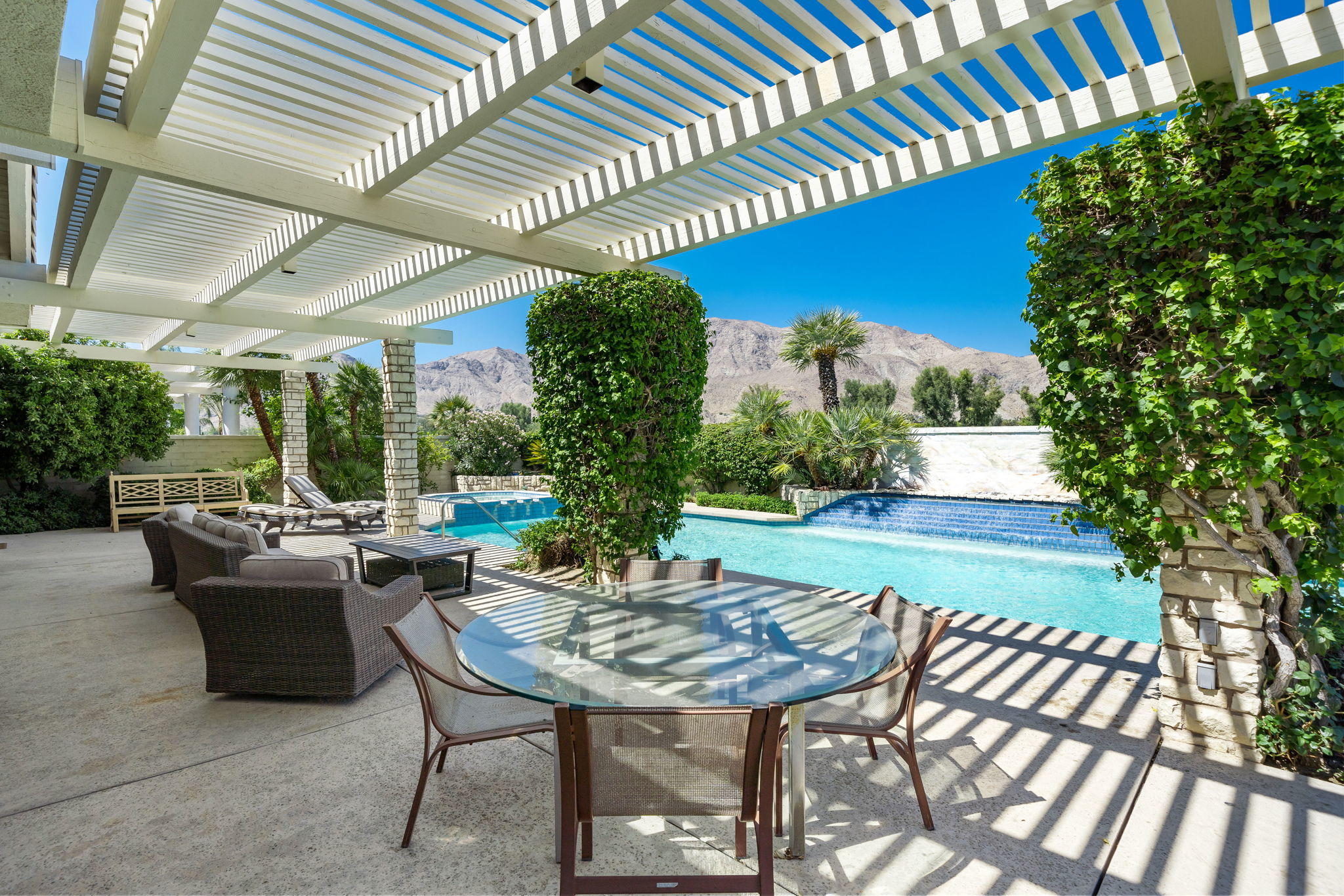74 Mayfair Drive Rancho Mirage, CA 92270 - Photo 26 of 35 a view of a patio with table and chairs and potted plants