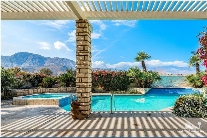 74 Mayfair Drive Rancho Mirage, CA 92270 - Photo 27 of 35 a view of a swimming pool with a yard and potted plants