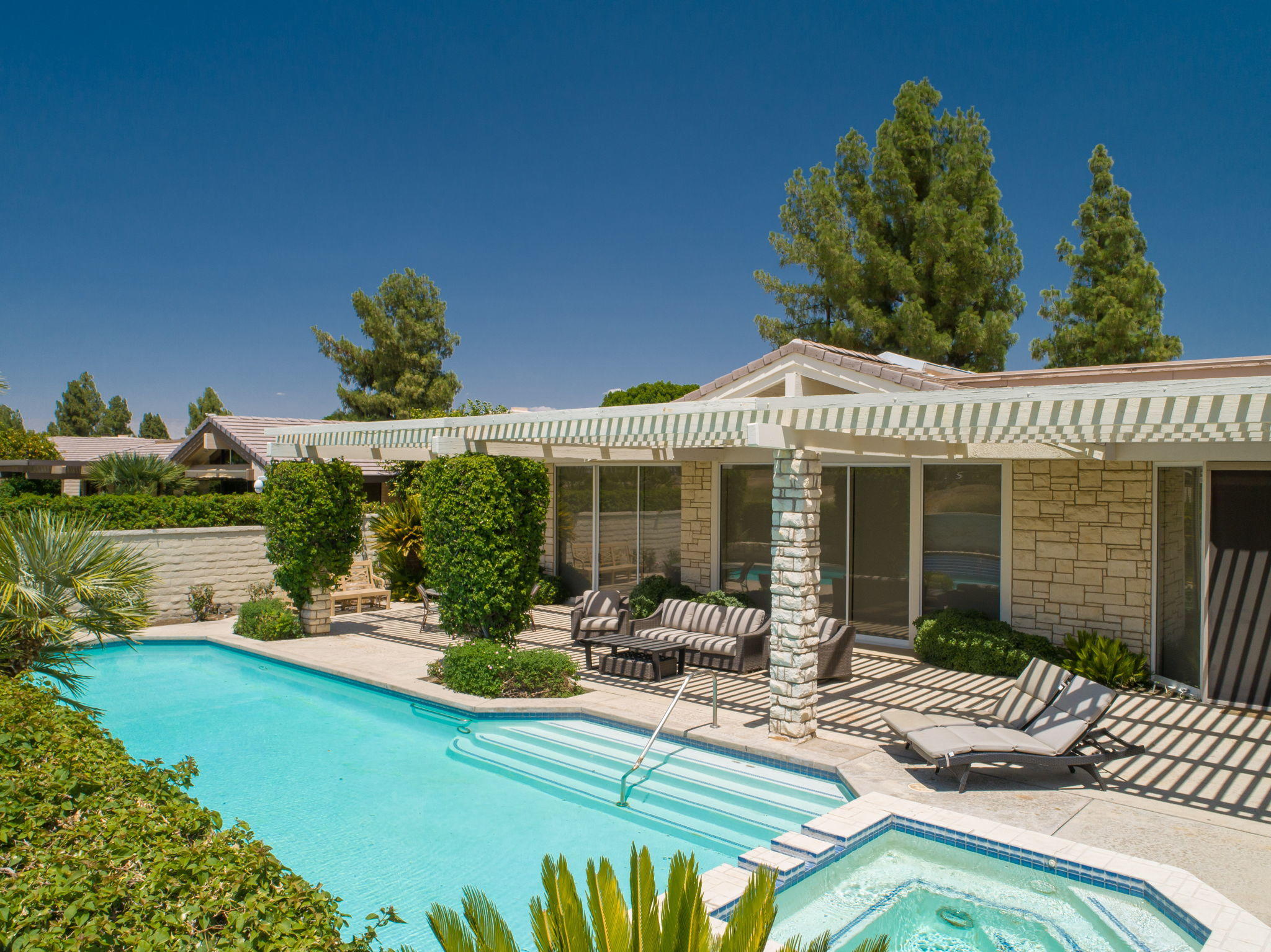 74 Mayfair Drive Rancho Mirage, CA 92270 - Photo 28 of 35 a view of a house with backyard patio and swimming pool