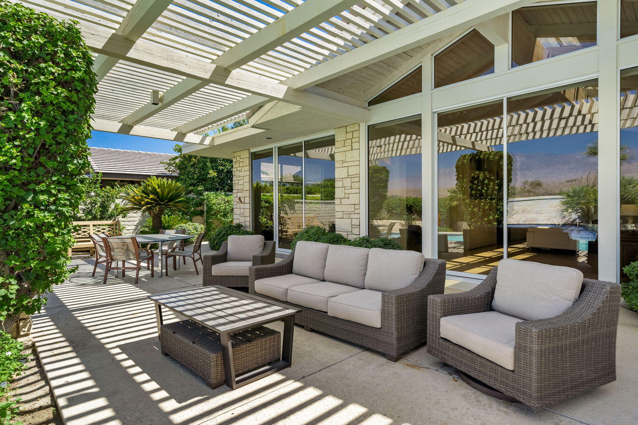 74 Mayfair Drive Rancho Mirage, CA 92270 - Photo 30 of 35 a view of a patio with couches and a potted plant on a table