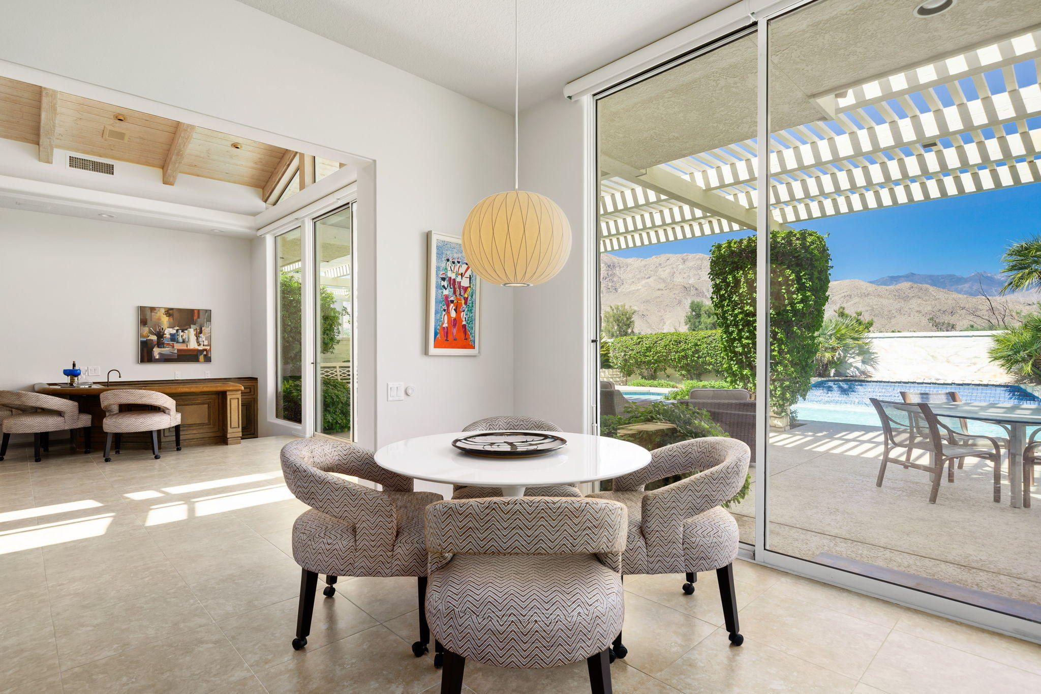 74 Mayfair Drive Rancho Mirage, CA 92270 - Photo 5 of 35 a dining room with furniture a rug and a chandelier
