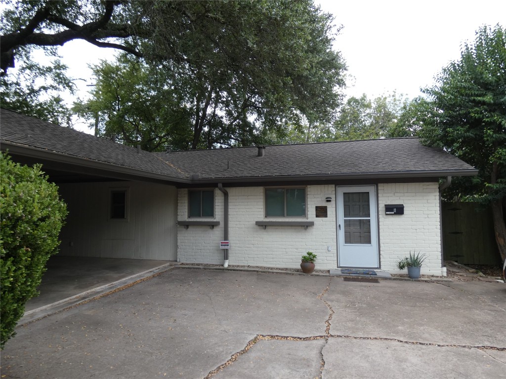 2203 Western Trails Boulevard, Unit B Austin, TX 78745 - Photo 1 of 33 a house with trees in the background