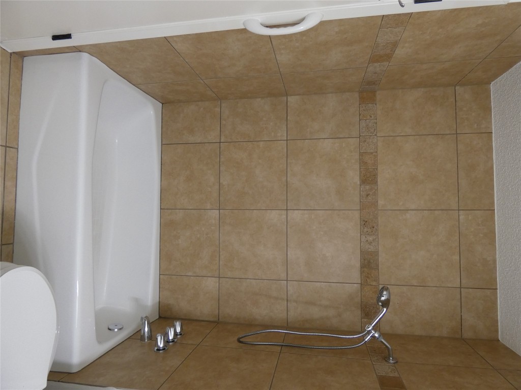 2203 Western Trails Boulevard, Unit B Austin, TX 78745 - Photo 17 of 33 a bathroom with a shower and a toilet