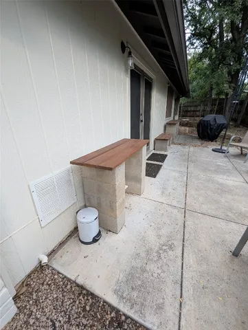 a view of backyard with outdoor seating and trees