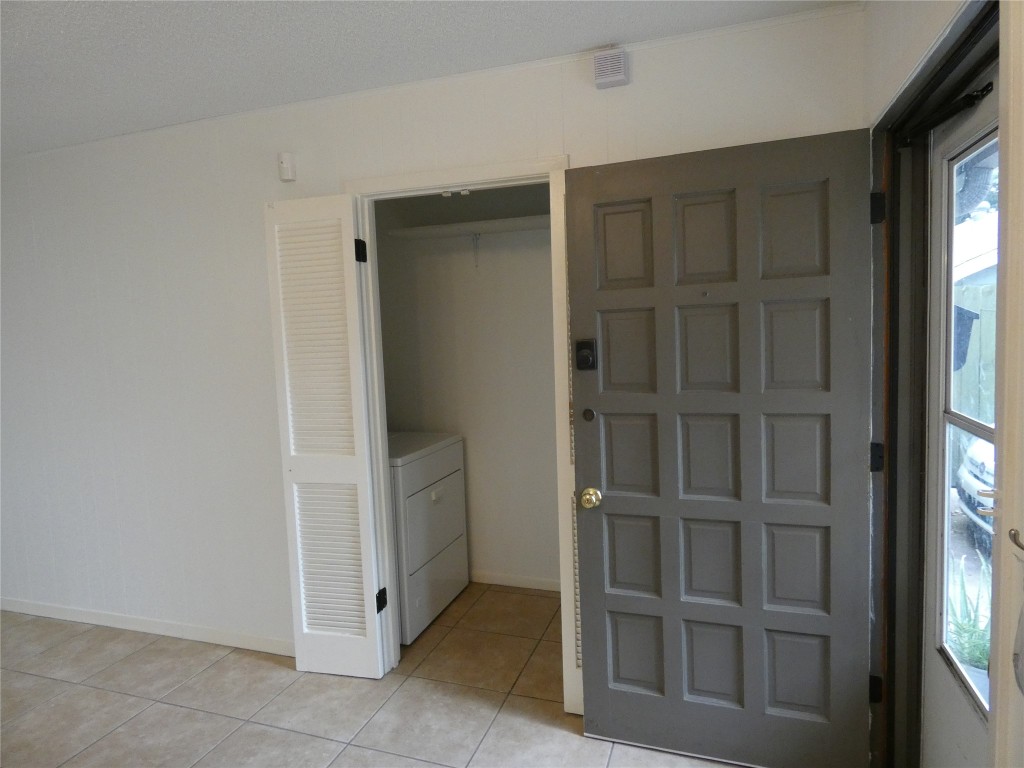 2203 Western Trails Boulevard, Unit B Austin, TX 78745 - Photo 3 of 33 a view of an empty room with cabinet and entryway