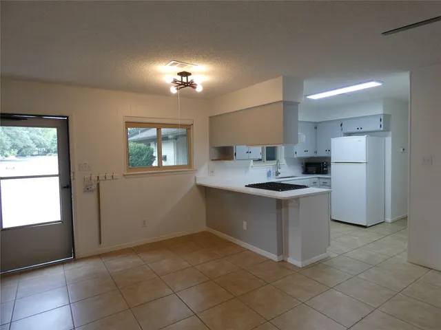 a kitchen with a refrigerator and a sink