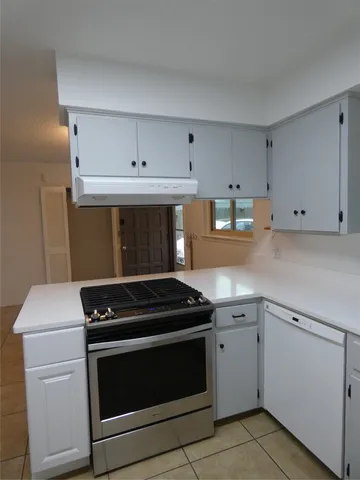 a kitchen with cabinets and appliances