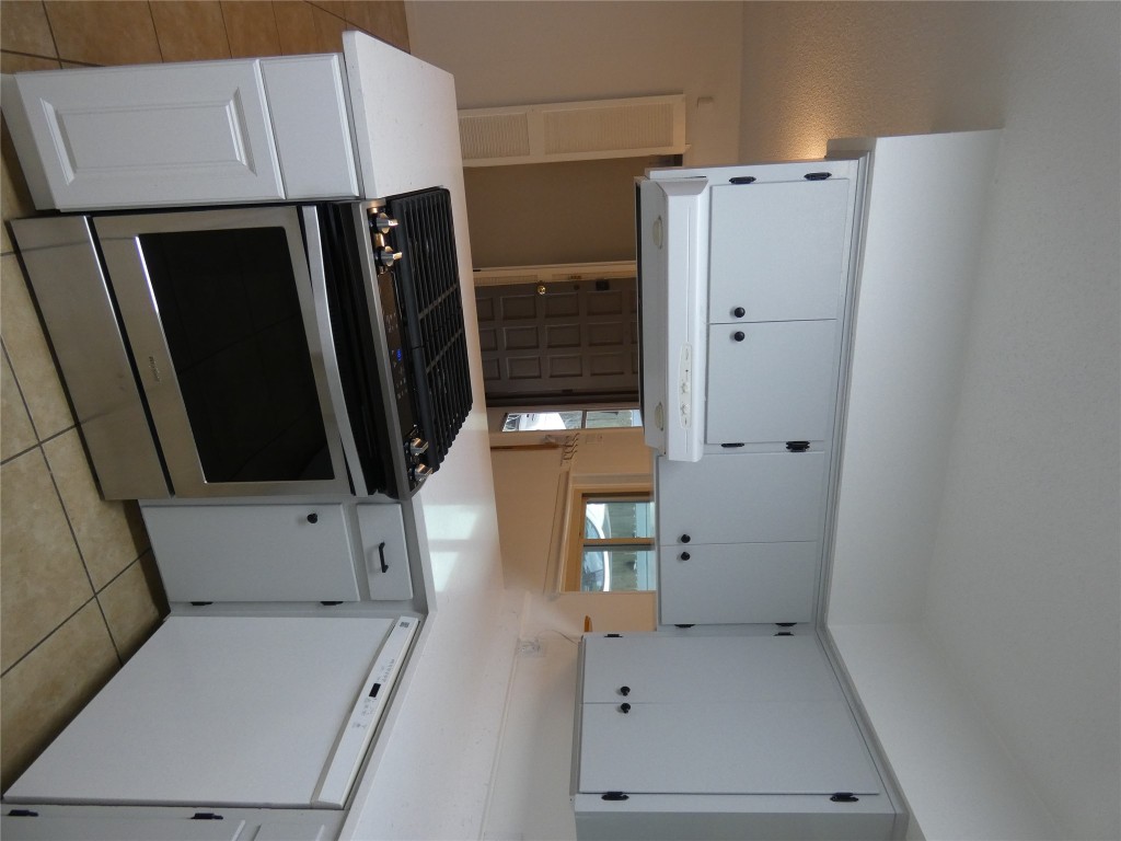 2203 Western Trails Boulevard, Unit B Austin, TX 78745 - Photo 6 of 33 a kitchen with cabinets and appliances