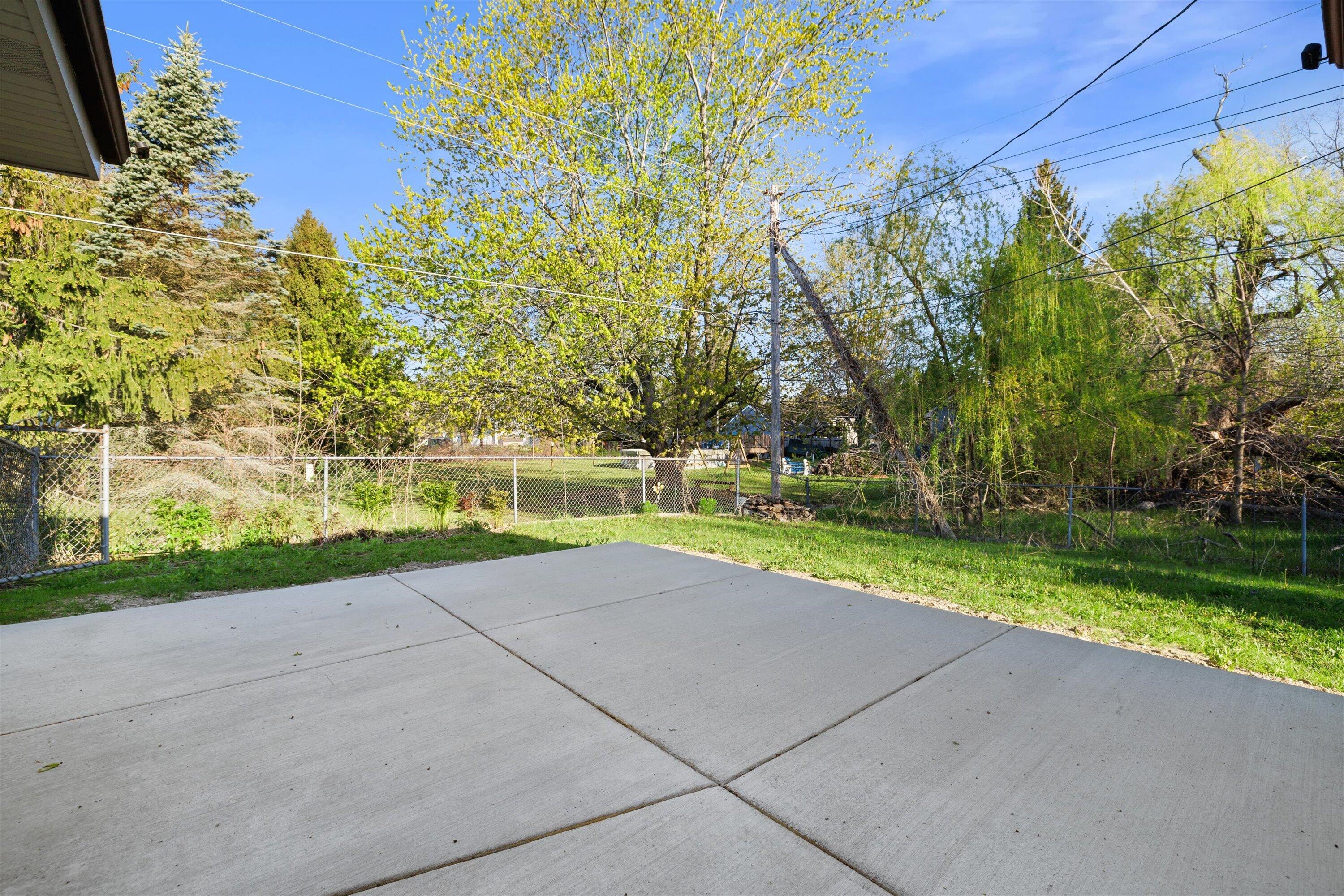 726 Royal Park Road Caledonia, WI 53402 - Photo 26 of 29 Step outside to a spacious concrete patio, ideal for summer evenings, outdoor dining, and relaxing while overlooking the backyard