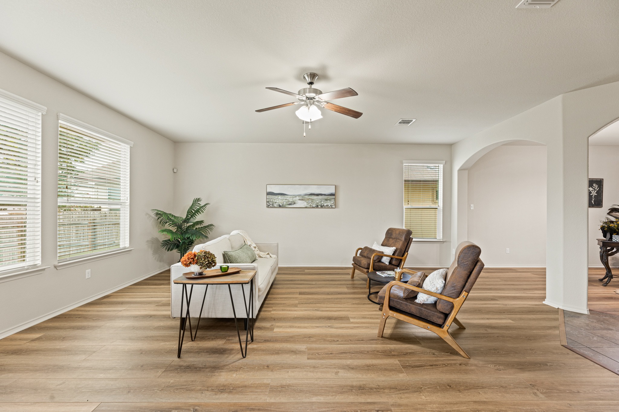 232 Geode Lane Jarrell, TX 76537 - Photo 39 of 39 An open floor plan features durable luxury vinyl flooring and an arched doorway leading to the entry.