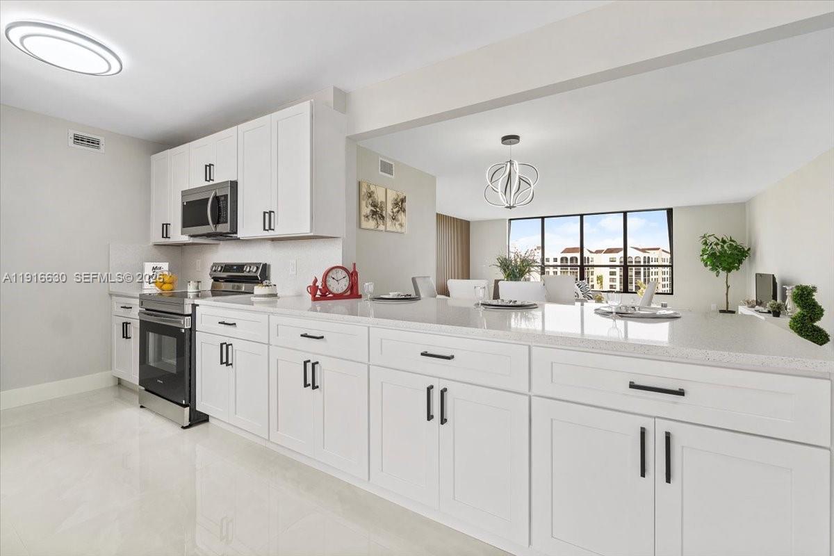 a kitchen with white cabinets and white appliances