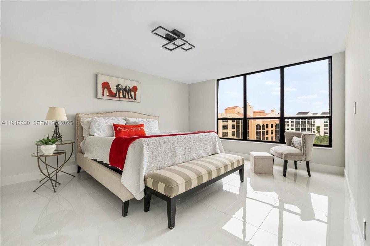 7129 Promenade Drive, Unit 801 Boca Raton, FL 33433 - Photo 15 of 42 a bed sitting in a bedroom next to a window