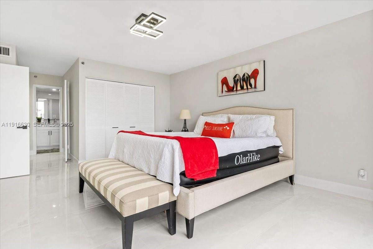 7129 Promenade Drive, Unit 801 Boca Raton, FL 33433 - Photo 17 of 42 a bedroom with a bed and a couch