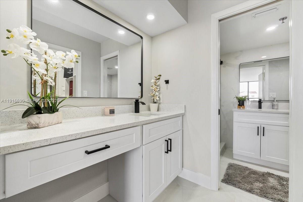 7129 Promenade Drive, Unit 801 Boca Raton, FL 33433 - Photo 19 of 42 a bathroom with a sink double vanity and a mirror