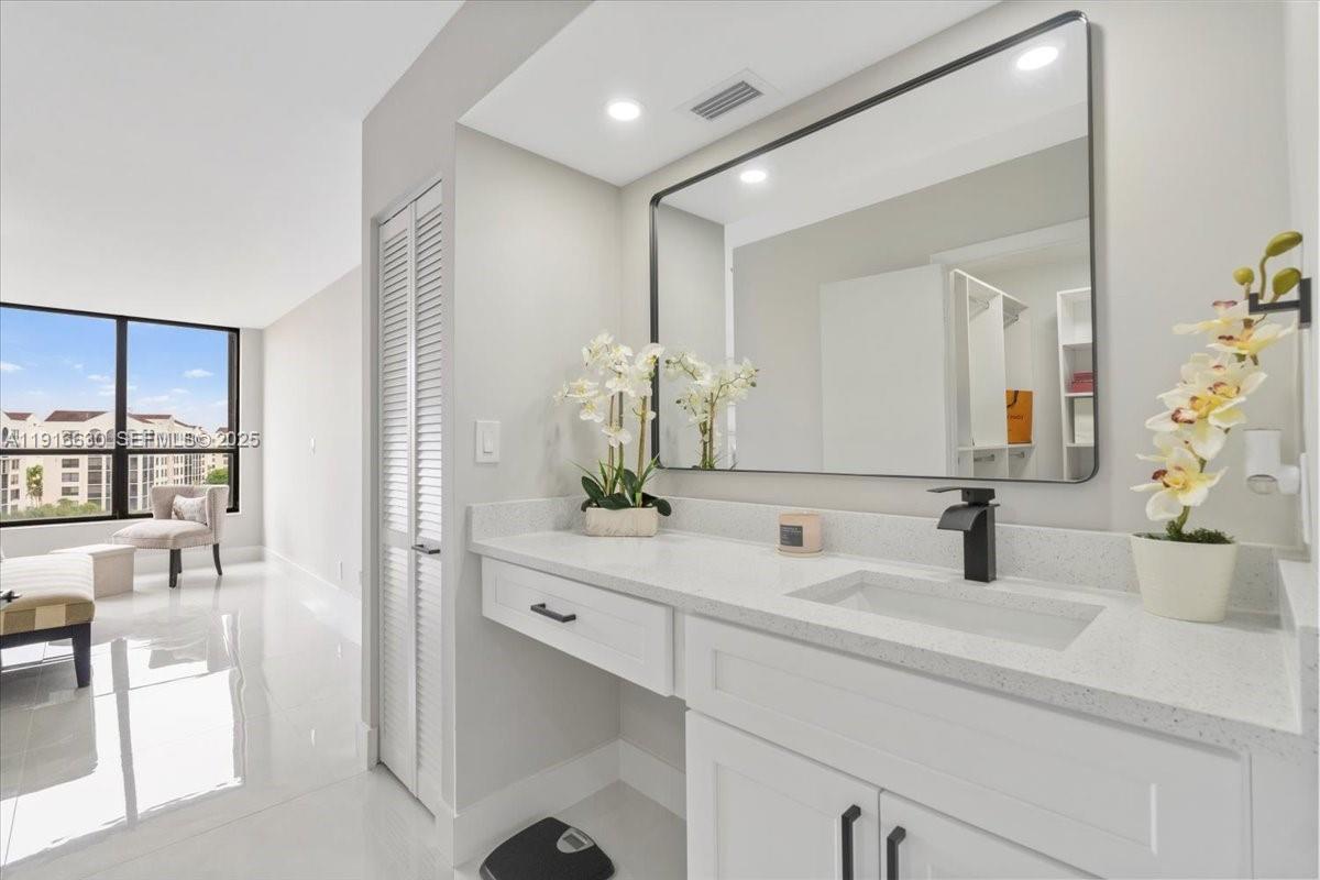 7129 Promenade Drive, Unit 801 Boca Raton, FL 33433 - Photo 24 of 42 a bathroom with a sink and a mirror