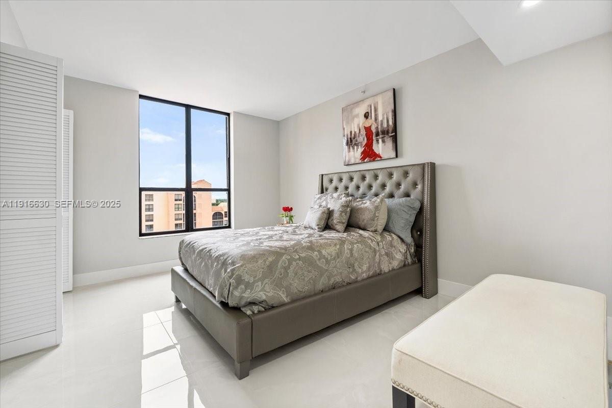 7129 Promenade Drive, Unit 801 Boca Raton, FL 33433 - Photo 25 of 42 a bed room with a bed and a window