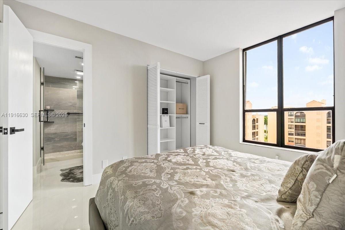 7129 Promenade Drive, Unit 801 Boca Raton, FL 33433 - Photo 27 of 42 a bedroom with a large bed and a large window