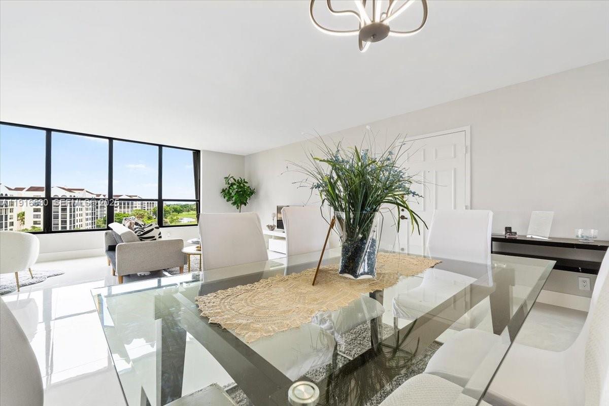 7129 Promenade Drive, Unit 801 Boca Raton, FL 33433 - Photo 3 of 42 a living room with furniture and large windows