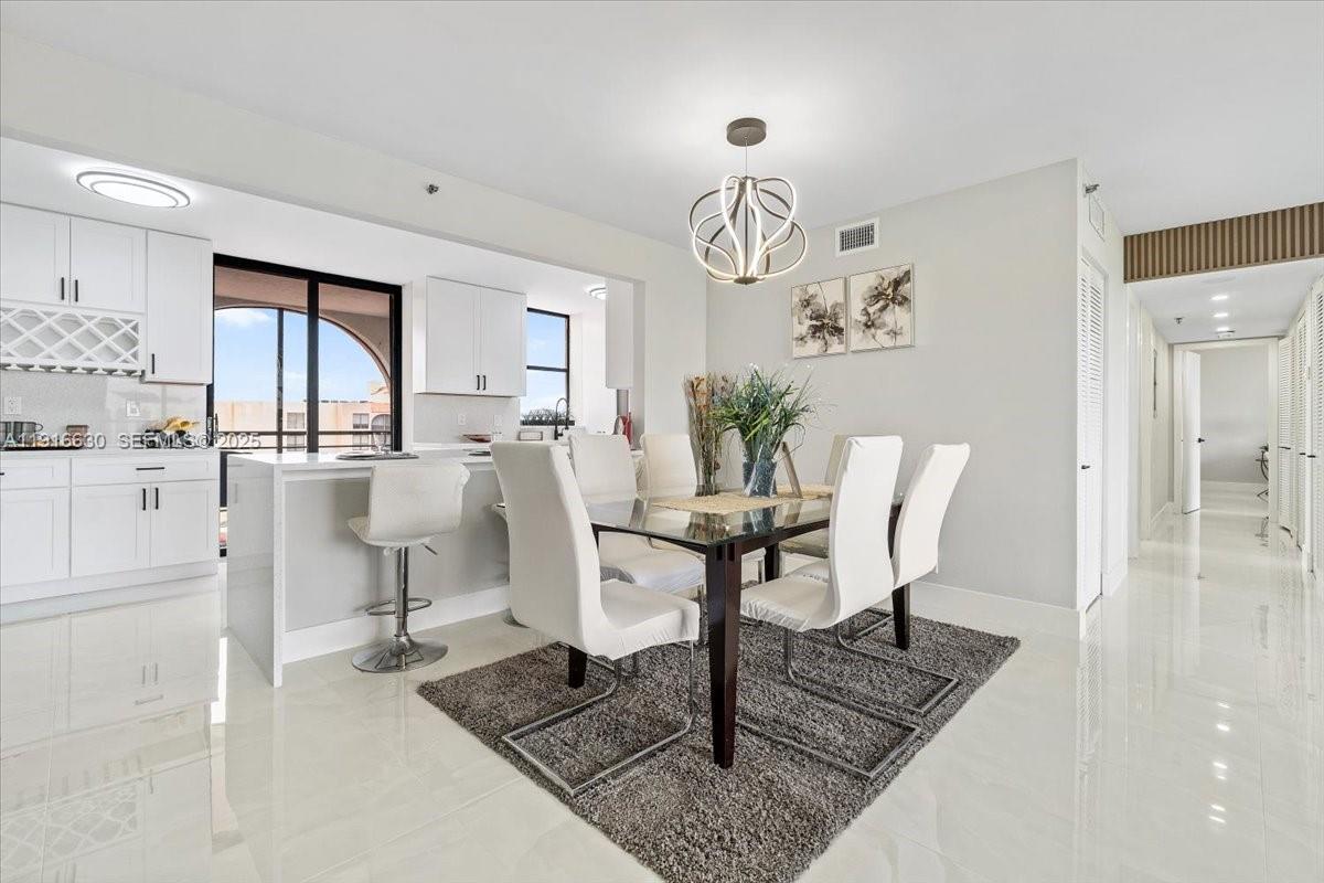 7129 Promenade Drive, Unit 801 Boca Raton, FL 33433 - Photo 4 of 42 a view of a dining room with furniture window and wooden floor