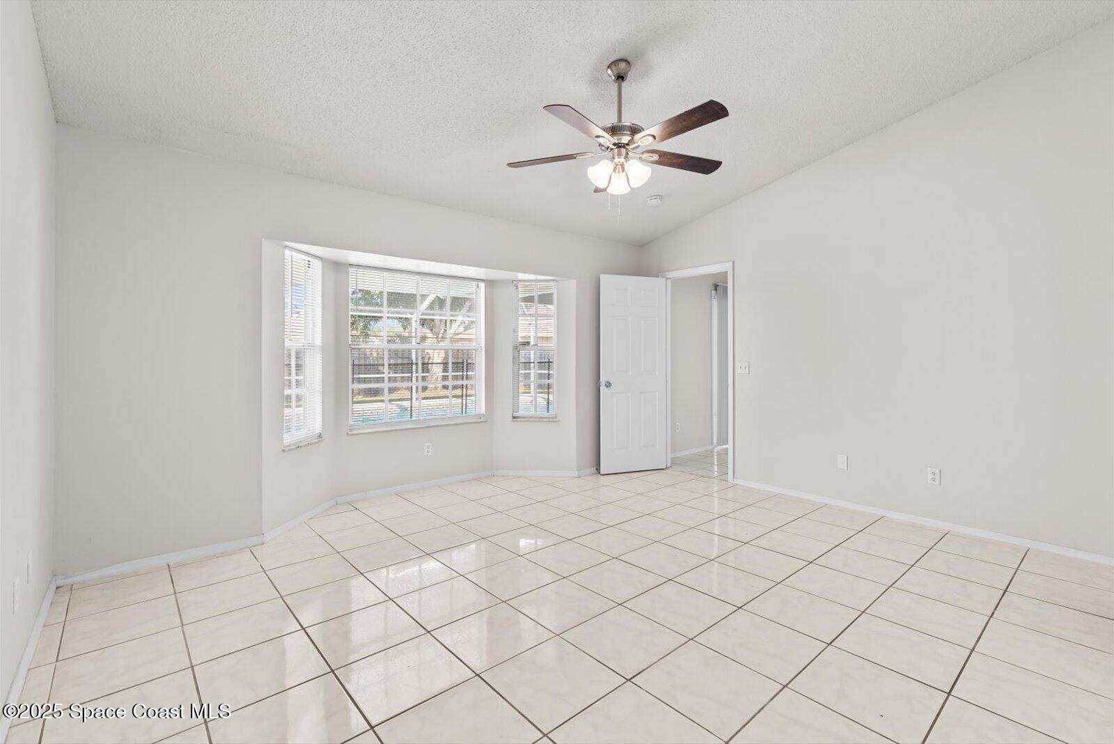 1037 Southwest California Boulevard Port St. Lucie, FL 34953 - Photo 16 of 38 a view of an empty room with a window