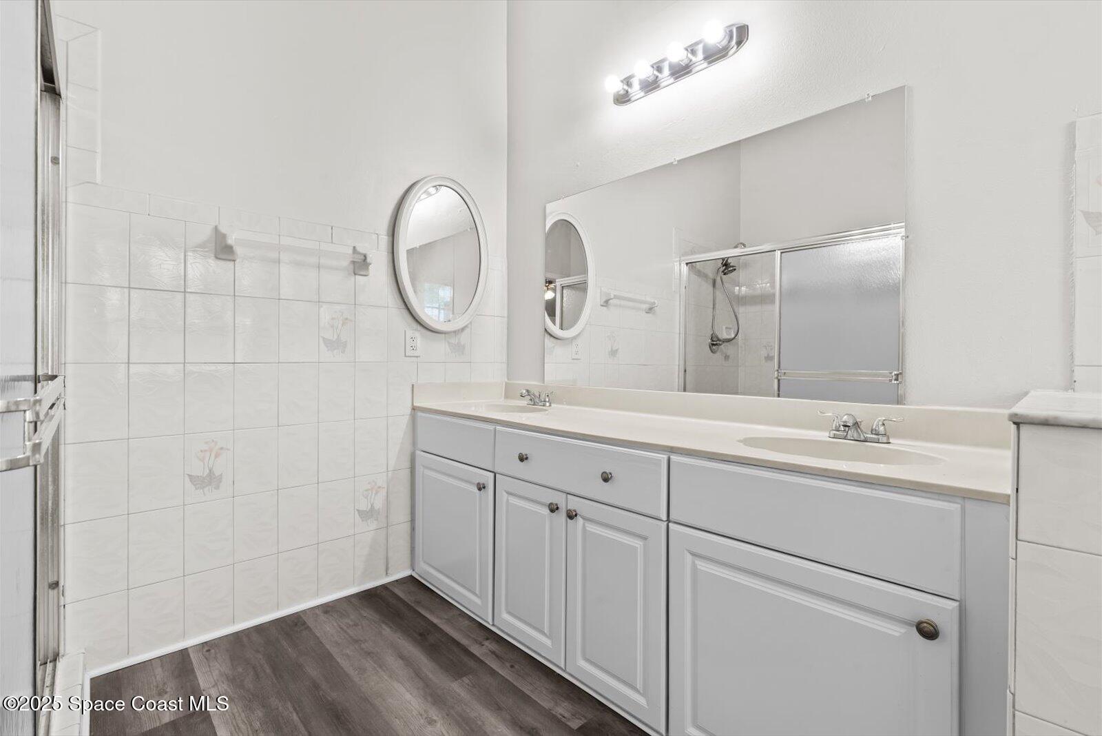 1037 Southwest California Boulevard Port St. Lucie, FL 34953 - Photo 18 of 38 a spacious bathroom with a double vanity sink and a mirror