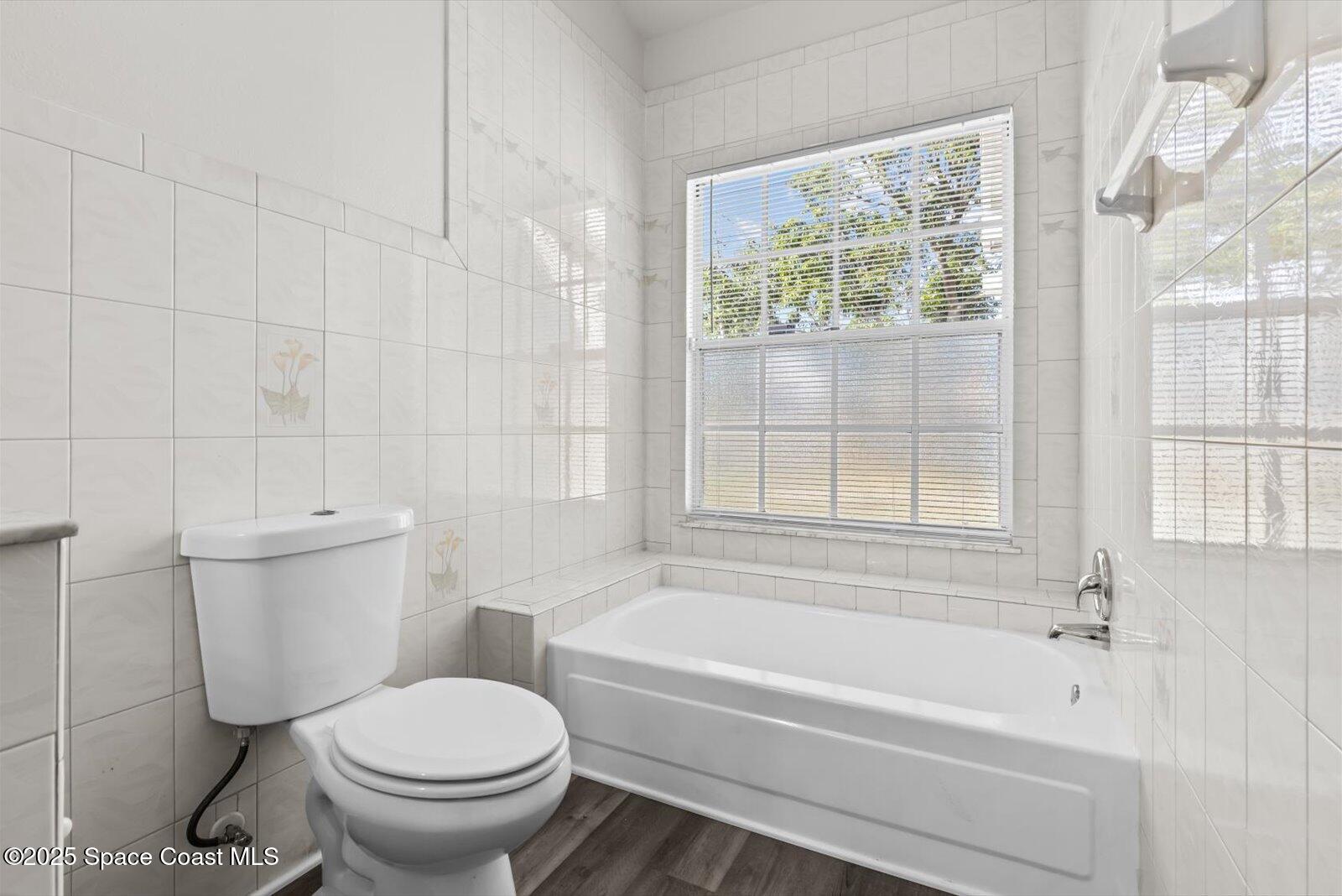 1037 Southwest California Boulevard Port St. Lucie, FL 34953 - Photo 20 of 38 a bathroom with a sink toilet and bathtub