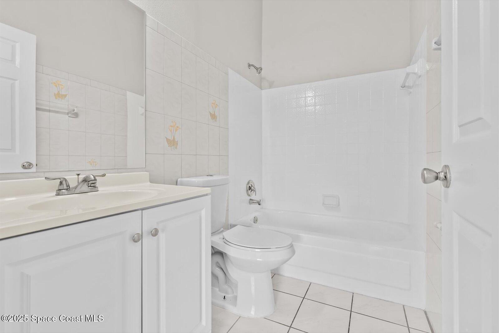 1037 Southwest California Boulevard Port St. Lucie, FL 34953 - Photo 24 of 38 a bathroom with a sink a toilet and shower