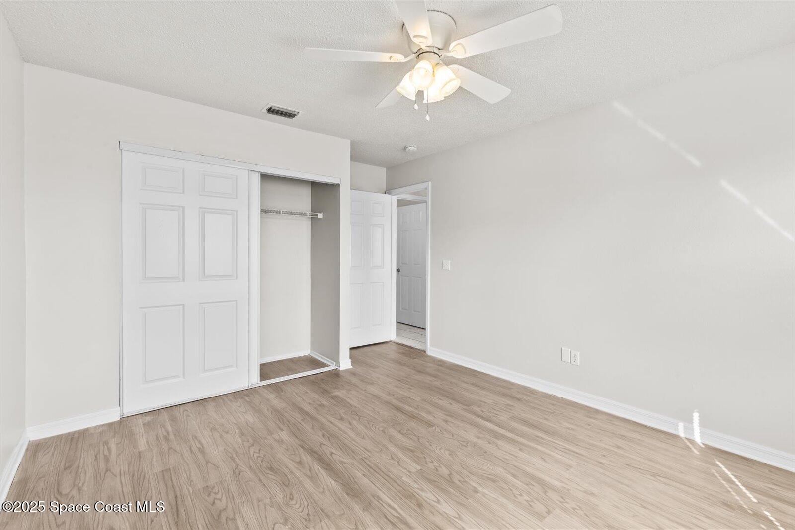 1037 Southwest California Boulevard Port St. Lucie, FL 34953 - Photo 26 of 38 a view of an empty room with wooden floor